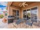 Covered patio with a grill and outdoor dining set, perfect for entertaining with picturesque scenery at 7380 E Canyon Wren Dr, Gold Canyon, AZ 85118