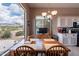 Cozy dining area offering scenic views of the Arizona landscape, adjacent to the kitchen at 7380 E Canyon Wren Dr, Gold Canyon, AZ 85118