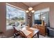 Inviting dining area with large windows showcasing mountain views and natural light at 7380 E Canyon Wren Dr, Gold Canyon, AZ 85118