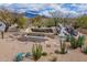 Charming community entrance with a rock waterfall feature and native desert landscaping at 7380 E Canyon Wren Dr, Gold Canyon, AZ 85118