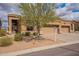 Charming home with a three-car garage and desert landscaping at 7380 E Canyon Wren Dr, Gold Canyon, AZ 85118