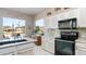 Well-equipped kitchen with black appliances, granite countertops and view of the mountains at 7380 E Canyon Wren Dr, Gold Canyon, AZ 85118