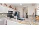 Modern kitchen featuring granite countertops, a kitchen island, and black stainless steel appliances at 7380 E Canyon Wren Dr, Gold Canyon, AZ 85118