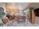 Comfortable living room area featuring a ceiling fan, plush seating, and seamless flow to the dining area at 7380 E Canyon Wren Dr, Gold Canyon, AZ 85118