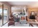 Cozy living room area with bar top, sliding door access to backyard, and stylish armchairs at 7380 E Canyon Wren Dr, Gold Canyon, AZ 85118