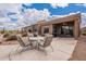 A covered patio with comfortable seating offers a relaxing outdoor living space at 7380 E Canyon Wren Dr, Gold Canyon, AZ 85118