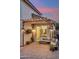 Backyard patio area featuring an outdoor sofa, lighting, television, and a stylish swing at dusk at 741 N Cholla St, Chandler, AZ 85224