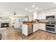 Modern kitchen features white cabinetry, stainless steel appliances, and an eat-in breakfast bar at 741 N Cholla St, Chandler, AZ 85224