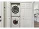 A stacked white washer and dryer located in a closet with panel doors at 741 N Cholla St, Chandler, AZ 85224