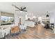 Open-concept living space featuring a flat screen tv, modern furnishings, and a breakfast nook at 741 N Cholla St, Chandler, AZ 85224