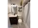 Well-lit bathroom with a modern vanity, sleek mirror, and decorative floating shelves at 817 N 95Th Pl, Mesa, AZ 85207
