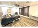 Bright bedroom featuring a bed, desk, and ceiling fan with window providing plenty of natural light at 817 N 95Th Pl, Mesa, AZ 85207