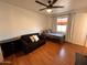 Comfortable bedroom with a seating area, natural light, and ceiling fan at 817 N 95Th Pl, Mesa, AZ 85207