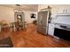 Open-concept dining area with hardwood floors, stainless steel appliances, and a seamless flow at 817 N 95Th Pl, Mesa, AZ 85207