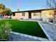 Charming single-story home boasts a lush lawn, desert landscaping and updated curb appeal at 817 N 95Th Pl, Mesa, AZ 85207