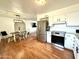 Well-lit kitchen flowing into living space, showcasing stainless steel appliances and white cabinets at 817 N 95Th Pl, Mesa, AZ 85207
