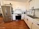 Well-equipped kitchen featuring stainless steel appliances, and bright white cabinetry at 817 N 95Th Pl, Mesa, AZ 85207