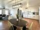 Bright kitchen with white cabinetry, stainless steel appliances, and adjacent dining area at 817 N 95Th Pl, Mesa, AZ 85207