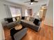 Inviting living room featuring a large sectional sofa, wood floors, and ample natural light at 817 N 95Th Pl, Mesa, AZ 85207