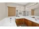 Luxurious bathroom featuring dual sinks, a soaking tub, and elegant lighting fixtures at 863 E Waterview Pl, Chandler, AZ 85249