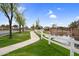Community showcasing picturesque walking paths and a serene pond bordered by a white fence at 863 E Waterview Pl, Chandler, AZ 85249