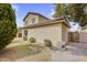 Exterior view featuring a well-maintained lawn, mature trees, and a neutral-toned stucco finish at 863 E Waterview Pl, Chandler, AZ 85249