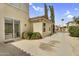 Exterior view showcasing a stucco home, mature trees, and paved patio area at 863 E Waterview Pl, Chandler, AZ 85249