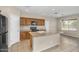 Kitchen featuring wooden cabinets and a central island that overlooks the dining area at 863 E Waterview Pl, Chandler, AZ 85249