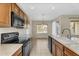 Bright kitchen featuring wooden cabinets, tile floors, and a view to the dining area at 863 E Waterview Pl, Chandler, AZ 85249