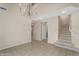 Airy living room featuring tile flooring, a chandelier, and a staircase, offering a grand and inviting atmosphere at 863 E Waterview Pl, Chandler, AZ 85249