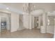 Elegant living room with tile floors, a chandelier, and a staircase leading upstairs, blending style with functionality at 863 E Waterview Pl, Chandler, AZ 85249