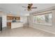 Open-concept living room with large windows, tile floors, and modern ceiling fan at 863 E Waterview Pl, Chandler, AZ 85249