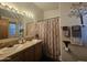 The bathroom features double sinks, wood-look cabinets and decorative elements at 8700 E University Dr # 649, Mesa, AZ 85207