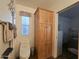 This is a bathroom with a small window, a toilet and a tall wooden cabinet at 8700 E University Dr # 649, Mesa, AZ 85207