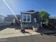 Charming single-story home with well-manicured landscaping and cozy outdoor seating area at 8700 E University Dr # 649, Mesa, AZ 85207