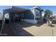 Charming single-story home with a covered carport and inviting outdoor seating area at 8700 E University Dr # 649, Mesa, AZ 85207