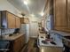 The kitchen features wooden cabinets, laminate countertops, and essential appliances, offering a functional cooking space at 8700 E University Dr # 649, Mesa, AZ 85207