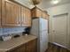 Cozy kitchen features wood cabinets, laminate counters and white appliances at 8700 E University Dr # 649, Mesa, AZ 85207