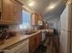 The kitchen features wood cabinets, laminate counters and white appliances with wood-look floors at 8700 E University Dr # 649, Mesa, AZ 85207