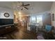 Open-concept living area features kitchen, dining, and living spaces under a ceiling fan for comfort at 8700 E University Dr # 649, Mesa, AZ 85207