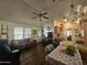 Cozy living room with a ceiling fan, wood-style flooring, adjacent to the kitchen and dining area at 8700 E University Dr # 649, Mesa, AZ 85207