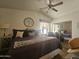 The main bedroom features a ceiling fan, a sitting chair, and mirrored closet doors at 8700 E University Dr # 649, Mesa, AZ 85207