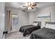 Comfortable bedroom with ceiling fan and two beds, each with gray linens at 9331 W Harmony Ln, Peoria, AZ 85382