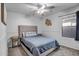 Bedroom featuring plush carpet, wainscotting, and ceiling fan at 9331 W Harmony Ln, Peoria, AZ 85382