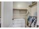 Bright closet with rods for hanging clothes, shelves, and a dresser with drawers at 9331 W Harmony Ln, Peoria, AZ 85382