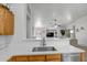 Modern kitchen sink and countertop overlooking living area at 9331 W Harmony Ln, Peoria, AZ 85382