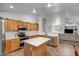 Beautiful kitchen with stainless steel appliances, light wood cabinets, and bright tile floors at 9331 W Harmony Ln, Peoria, AZ 85382