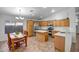 Eat-in kitchen with light wood cabinets, center island, stainless steel appliances, and tile floor at 9331 W Harmony Ln, Peoria, AZ 85382