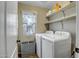 Laundry room with washer, dryer, window, and tile floor at 9331 W Harmony Ln, Peoria, AZ 85382