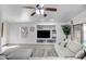 Cozy living room featuring built-in media center, neutral decor, and plush, comfy furniture at 9331 W Harmony Ln, Peoria, AZ 85382